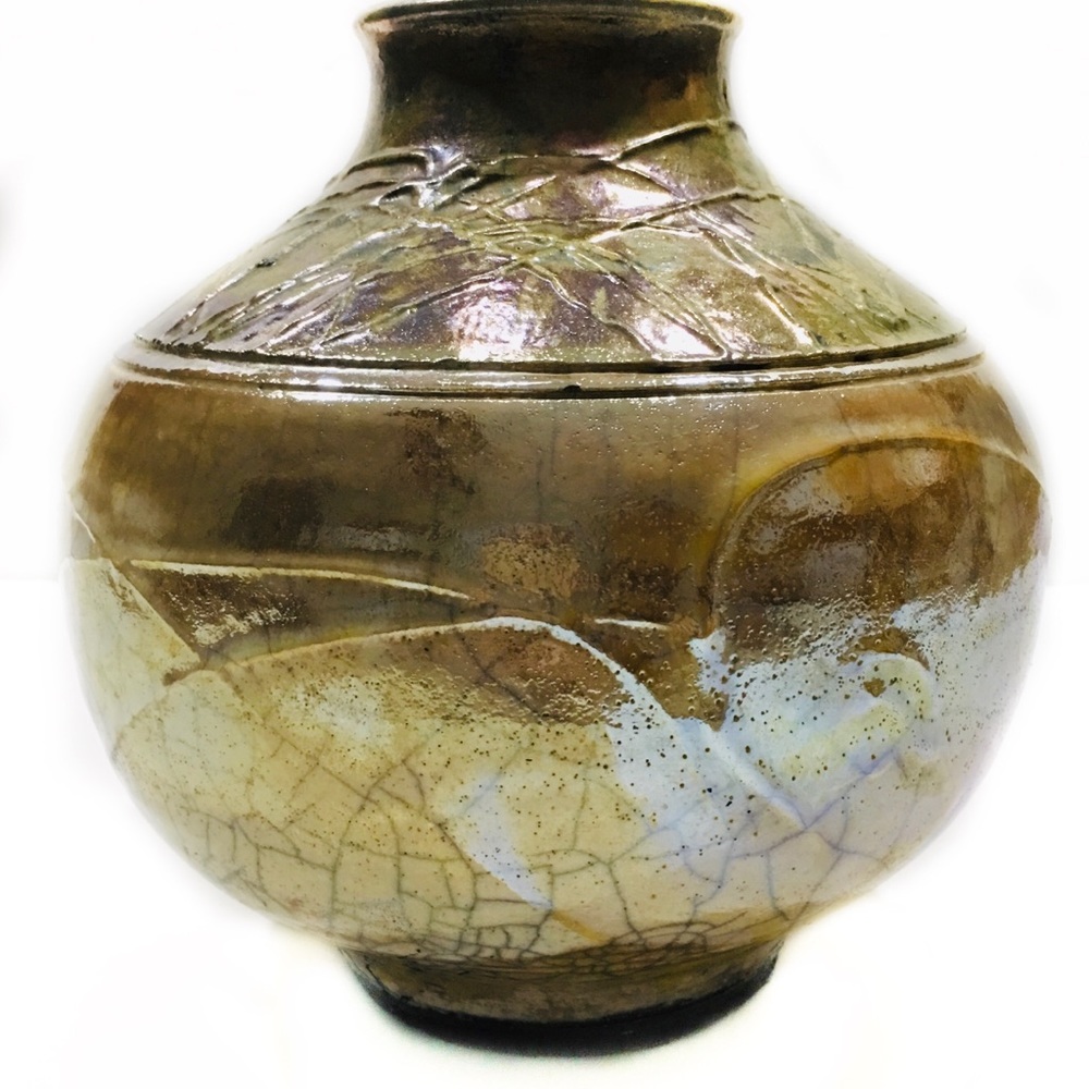 raku, clay pot iridescent gold, copper. signed